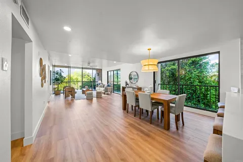 a kitchen with stainless steel appliances granite countertop a sink and a wooden floor
