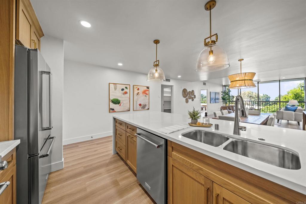 2500 Torrey Pines Road, Unit 305 La Jolla, CA 92037 - Photo 9 of 48 a kitchen with stainless steel appliances granite countertop a sink and a wooden floor