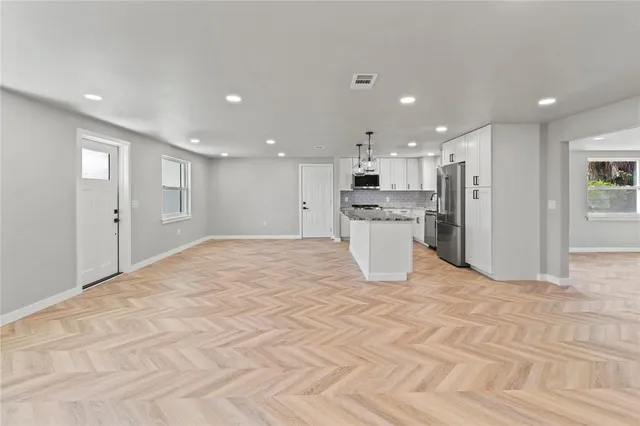 a view of a kitchen with a sink and a refrigerator