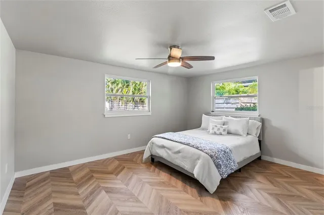 a bedroom with a large bed and a window