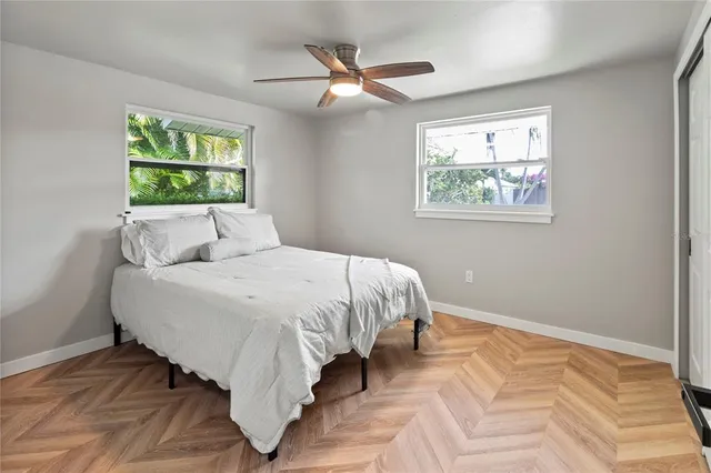 a bed sitting in a bedroom next to a window