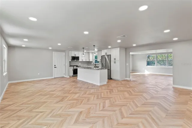 a view of a kitchen with a sink and a refrigerator