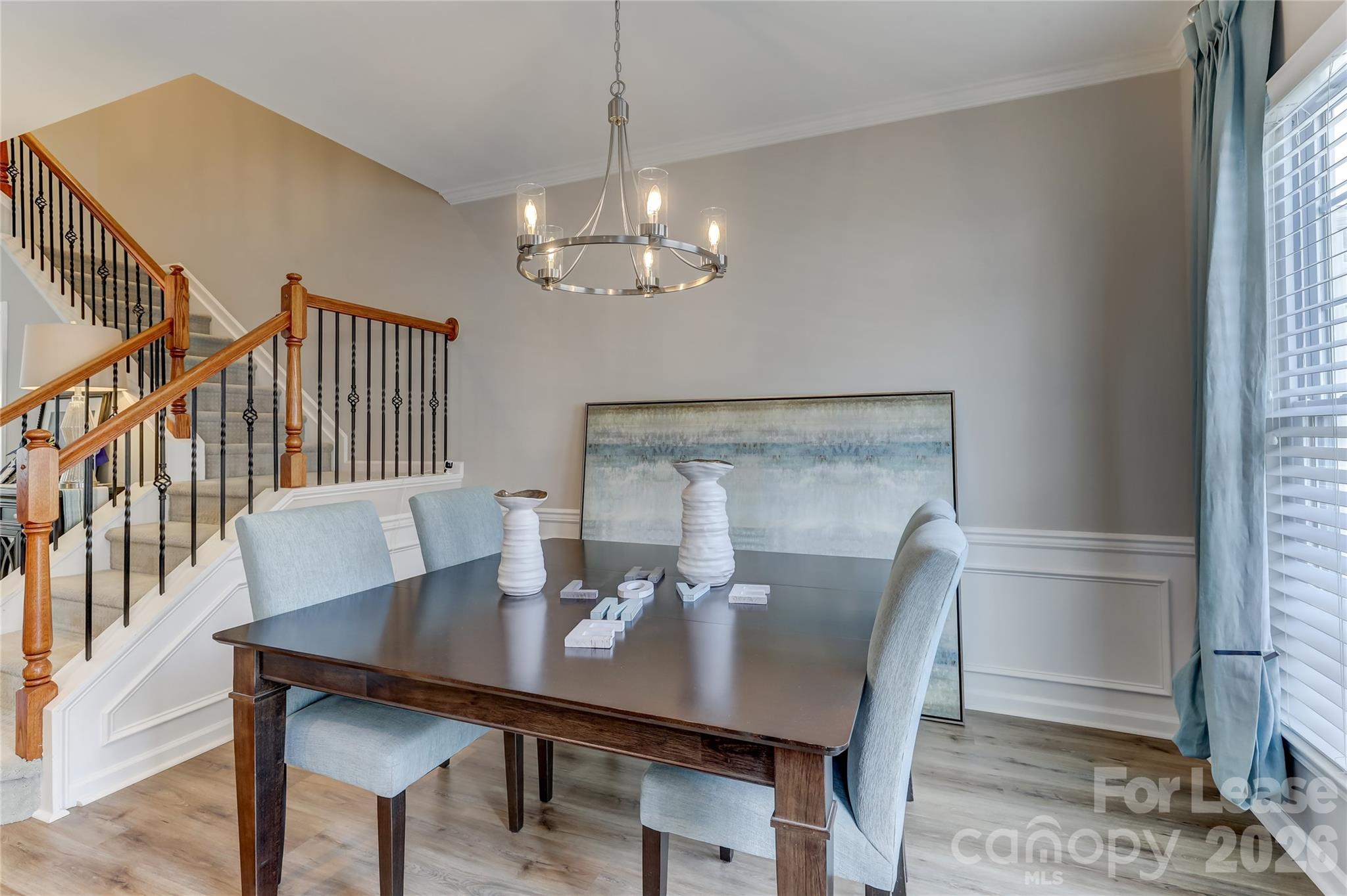 905 Lyndley Drive Fort Mill, SC 29708 - Photo 11 of 42 a view of a dining room with furniture a chandelier and wooden floor
