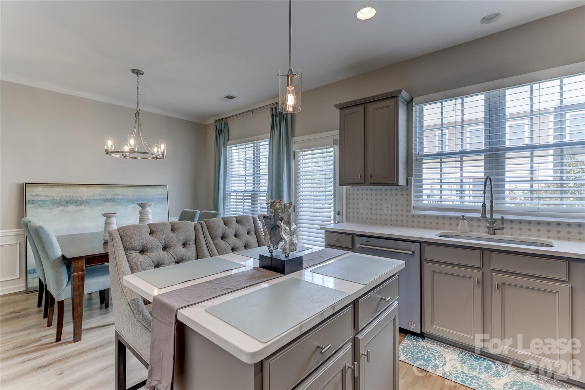 905 Lyndley Drive Fort Mill, SC 29708 - Photo 15 of 42 a kitchen with a table chairs sink and cabinets