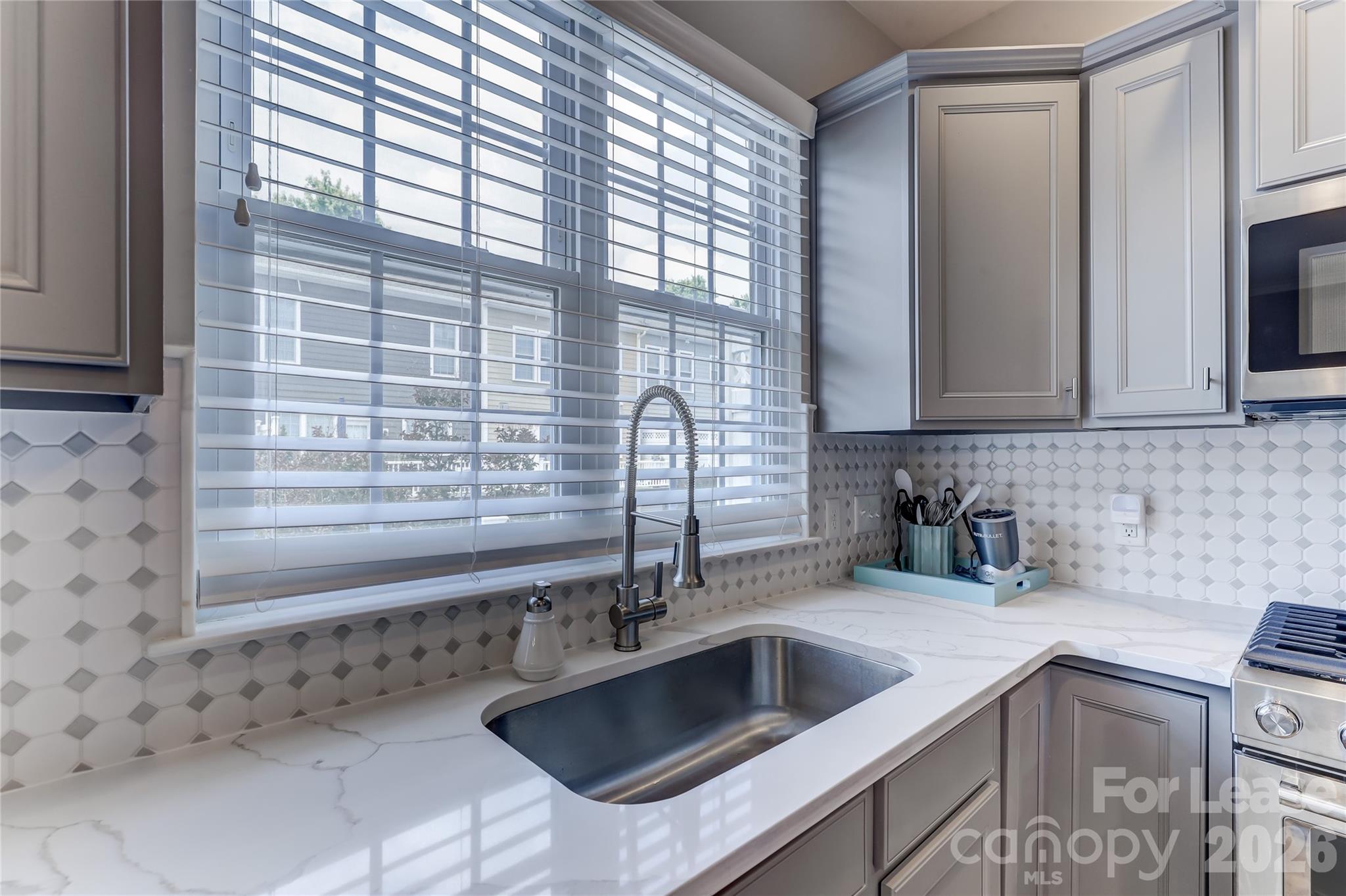 905 Lyndley Drive Fort Mill, SC 29708 - Photo 17 of 42 a kitchen with granite countertop a sink and a window