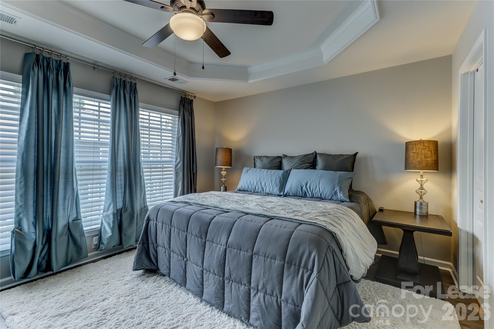 905 Lyndley Drive Fort Mill, SC 29708 - Photo 32 of 42 a bedroom with a bed and a chandelier