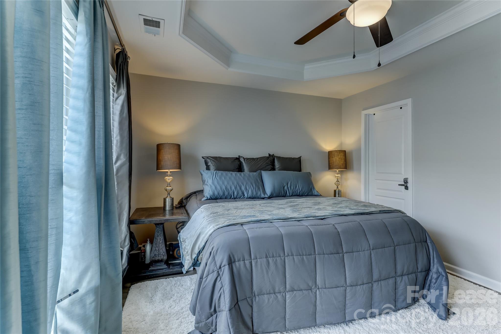 905 Lyndley Drive Fort Mill, SC 29708 - Photo 33 of 42 a bedroom with a bed and a chandelier