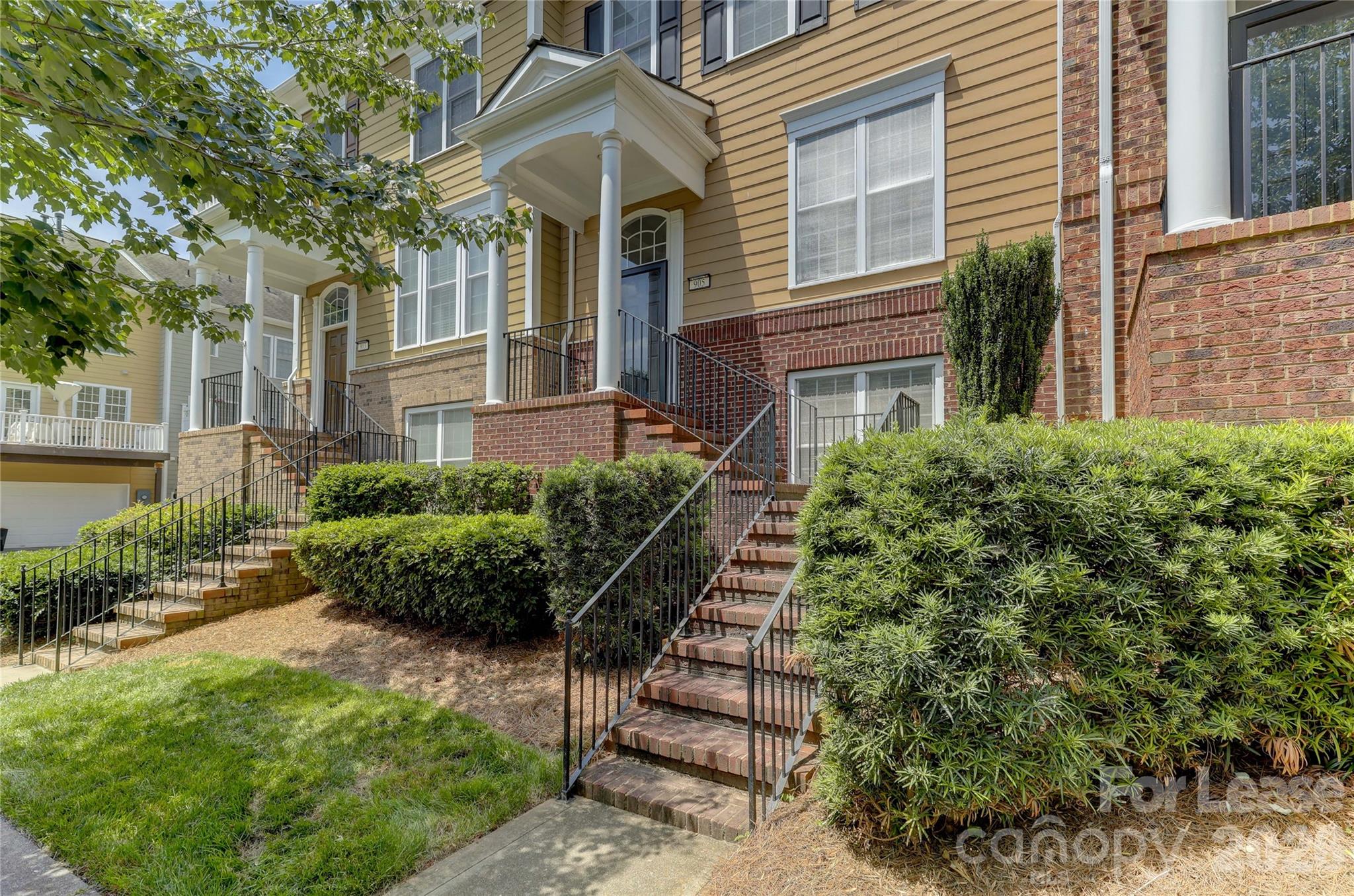 905 Lyndley Drive Fort Mill, SC 29708 - Photo 4 of 42 a view of a brick house with a yard and plants