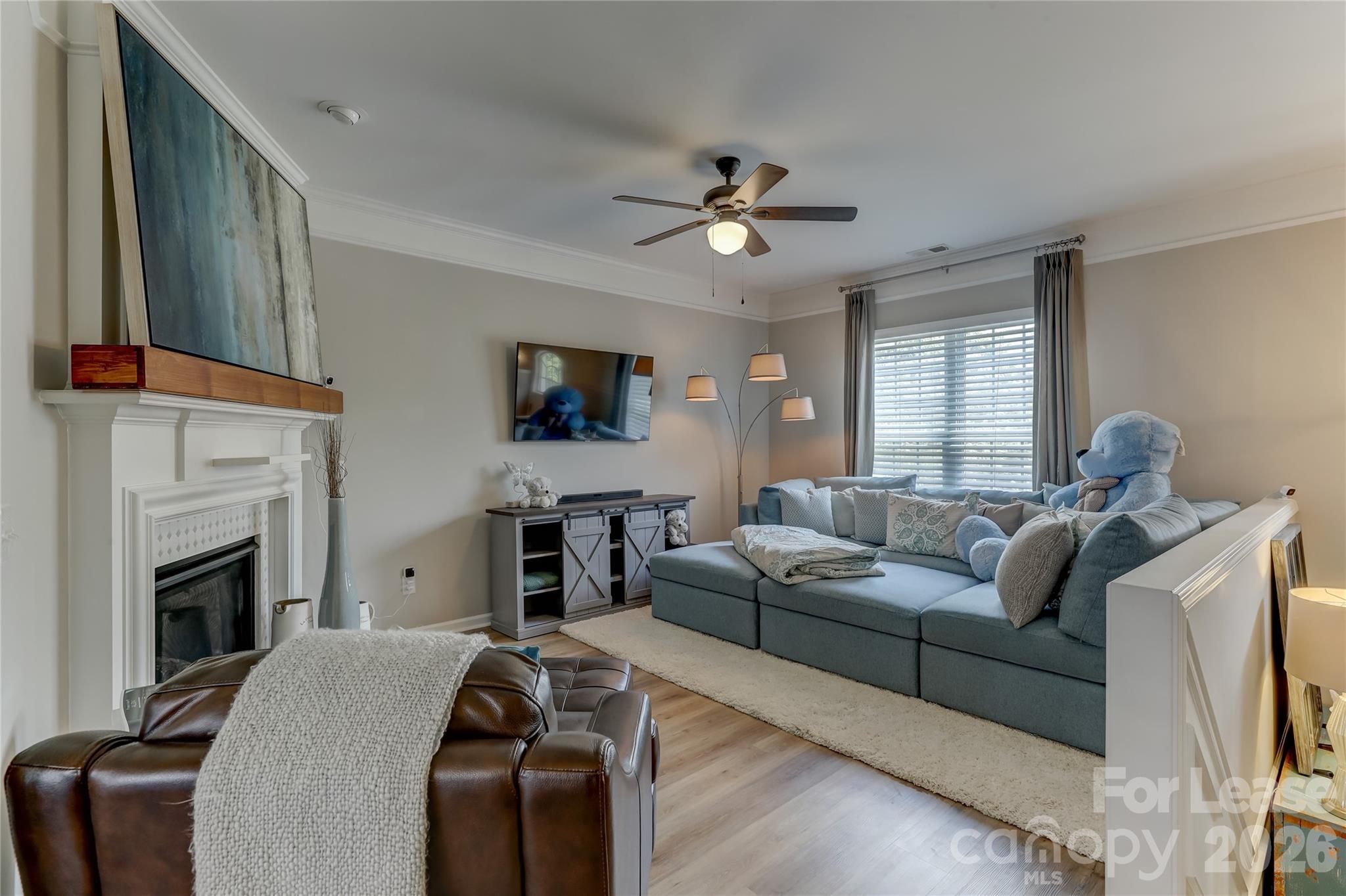 905 Lyndley Drive Fort Mill, SC 29708 - Photo 7 of 42 a living room with furniture a fireplace and a flat screen tv