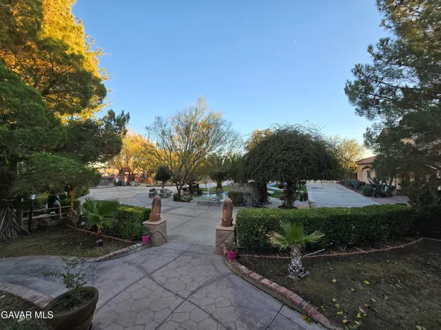 a kitchen with stainless steel appliances granite countertop a sink a stove and a wooden cabinets