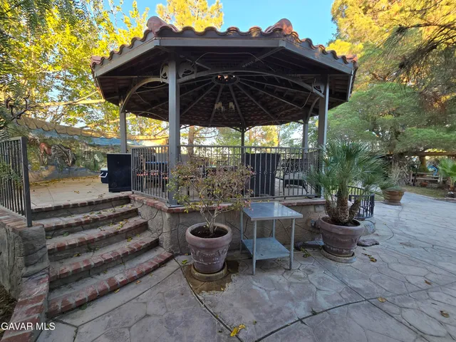 a bedroom with a bed a flat screen tv and a fireplace