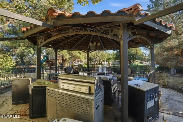 a living room with furniture a large window and a chandelier