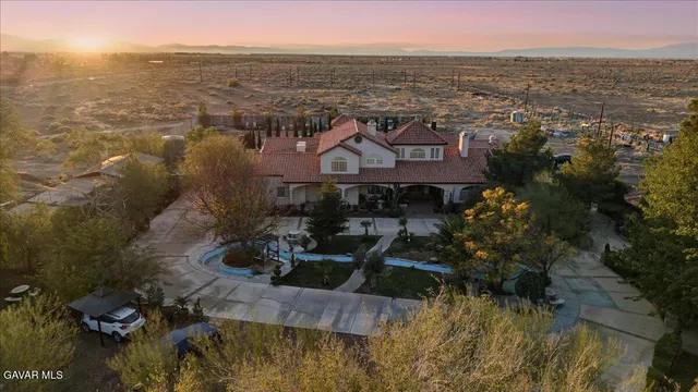 a view of a patio with couches chairs and a wooden floor