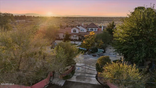 a view of a patio with table and chairs and potted plants
