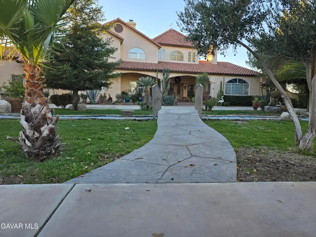 a view of an outdoor dining space with a table and chairs