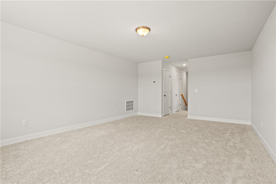 554 Hydrangea Street, Unit LOT 67 Seneca, SC 29678 - Photo 21 of 26 A spacious room offers ample potential, featuring soft carpeting and a clear passageway.