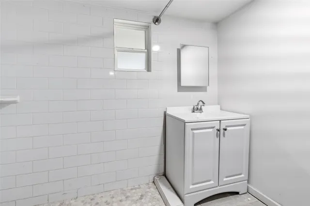 a bathroom with a sink vanity and a mirror