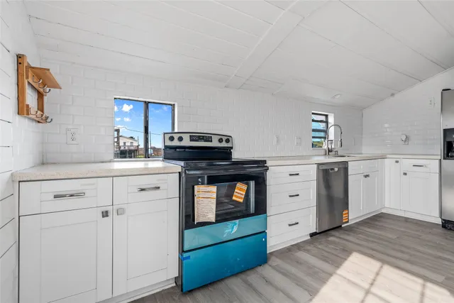 a kitchen with cabinets appliances and a sink