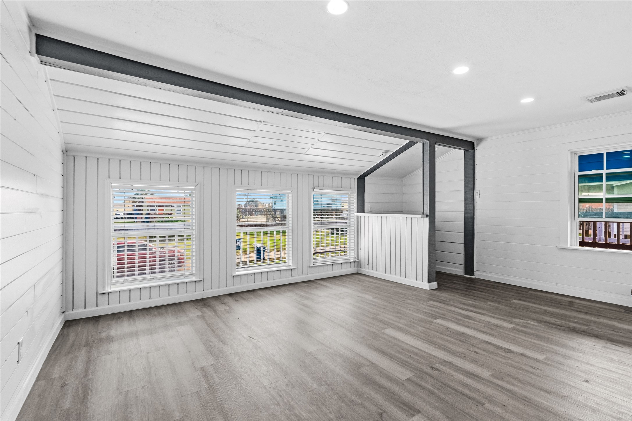 416 Seabean Street Surfside Beach, TX 77541 - Photo 18 of 27 an empty room with wooden floor and windows