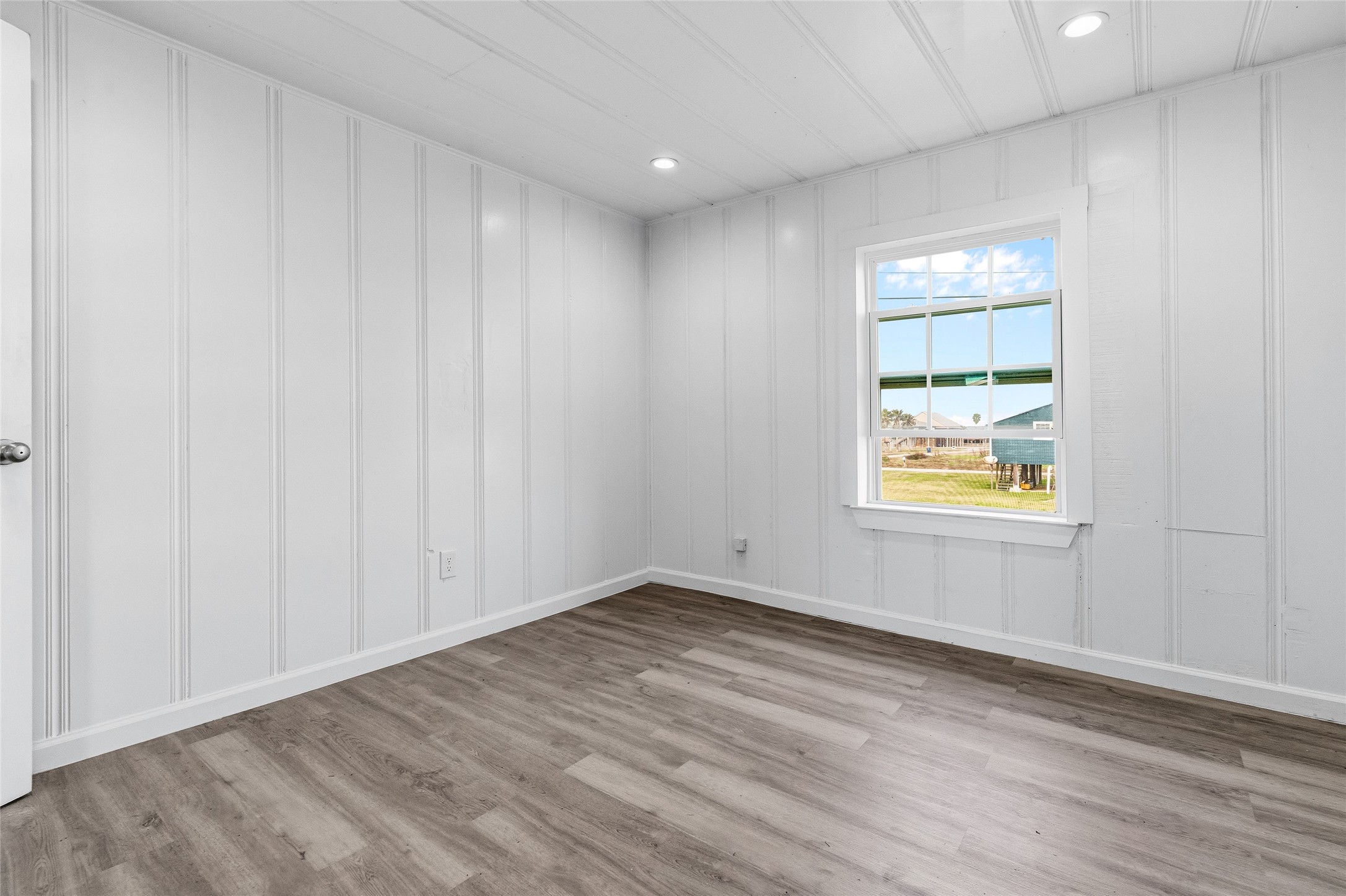 416 Seabean Street Surfside Beach, TX 77541 - Photo 19 of 27 wooden floor in an empty room with a window