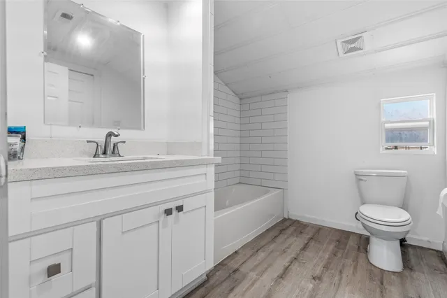 a bathroom with a sink a toilet and bathtub