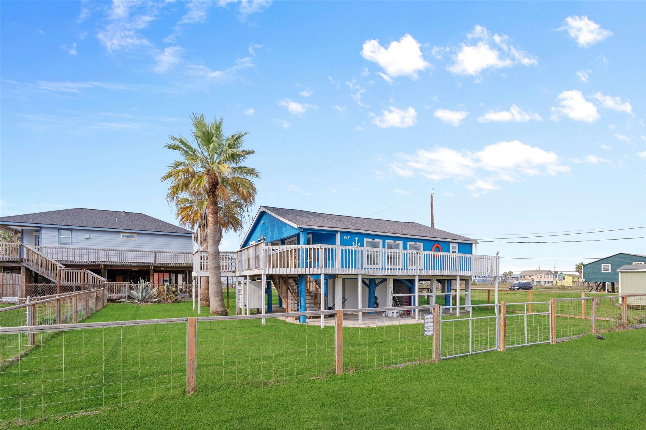 416 Seabean Street Surfside Beach, TX 77541 - Photo 3 of 27 a view of a house with a big yard and large trees