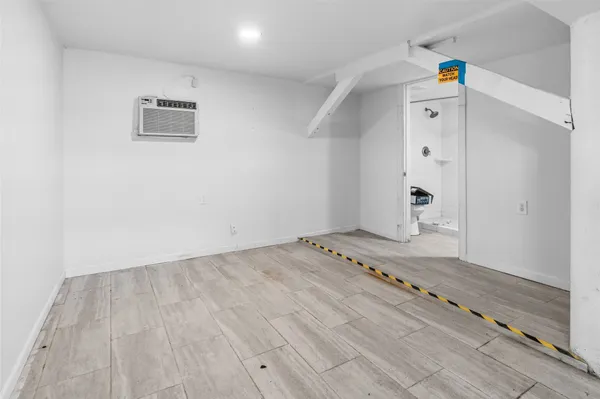 a view of a room with wooden floor