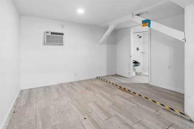 a view of a room with wooden floor