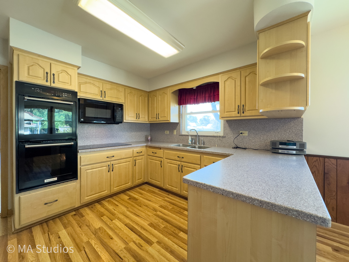 8636 40th Street Lyons, IL 60534 - Photo 11 of 50 a kitchen with stainless steel appliances granite countertop a stove a sink and a microwave