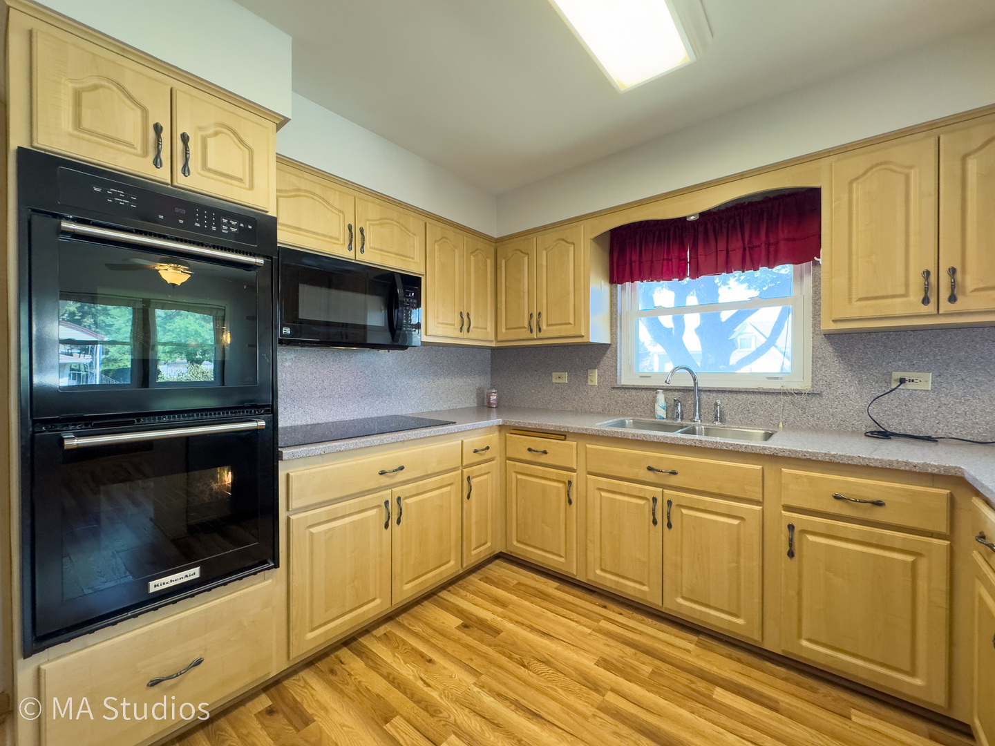 8636 40th Street Lyons, IL 60534 - Photo 12 of 50 a kitchen with stainless steel appliances granite countertop a stove a sink and a microwave