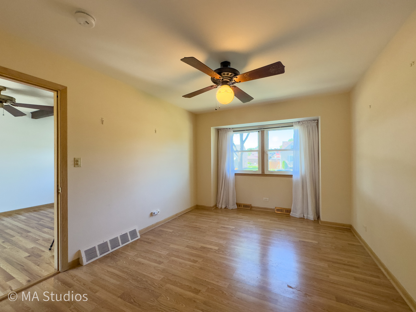 8636 40th Street Lyons, IL 60534 - Photo 17 of 50 a view of empty room with wooden floor and fan