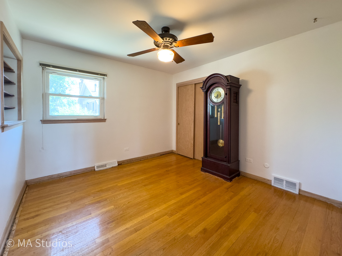 8636 40th Street Lyons, IL 60534 - Photo 19 of 50 a view of an empty room with a chandelier fan and a window