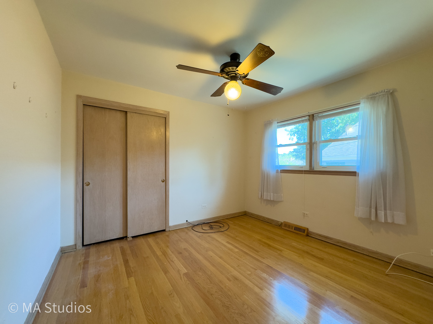 8636 40th Street Lyons, IL 60534 - Photo 22 of 50 a view of empty room with wooden floor and fan