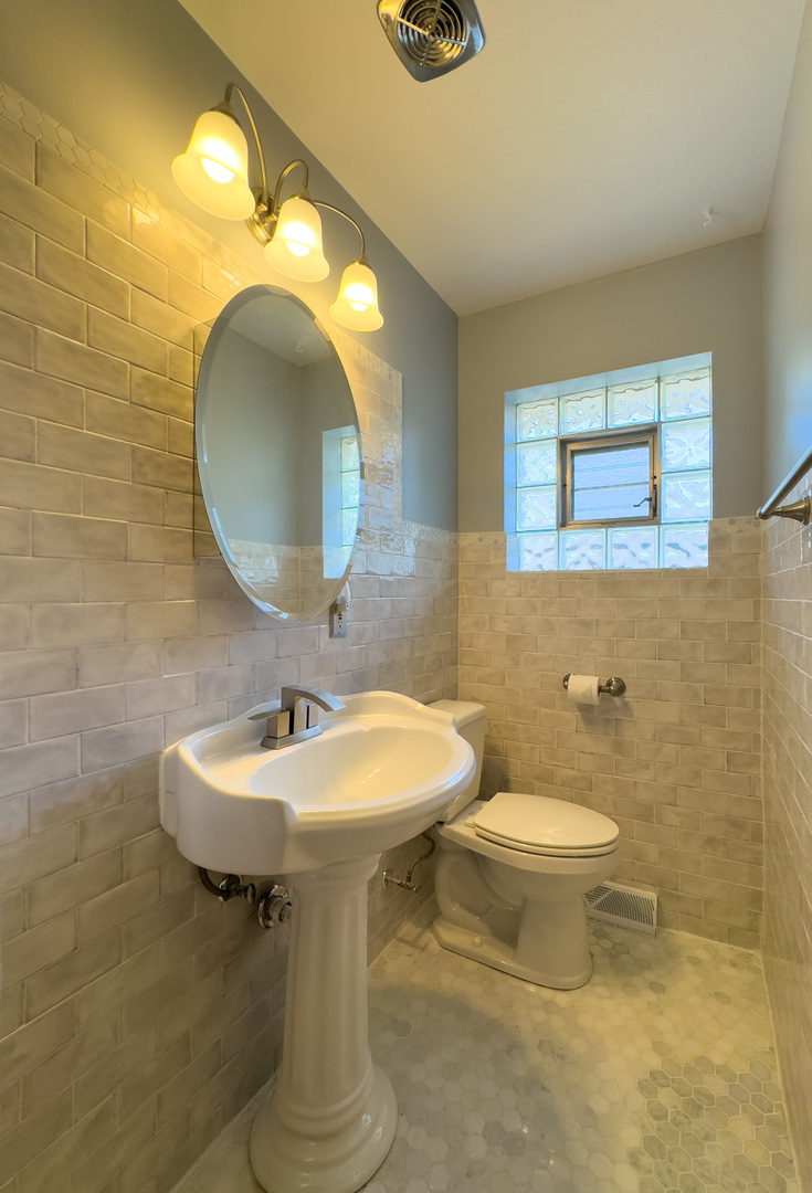 8636 40th Street Lyons, IL 60534 - Photo 23 of 50 a bathroom with a toilet sink and mirror