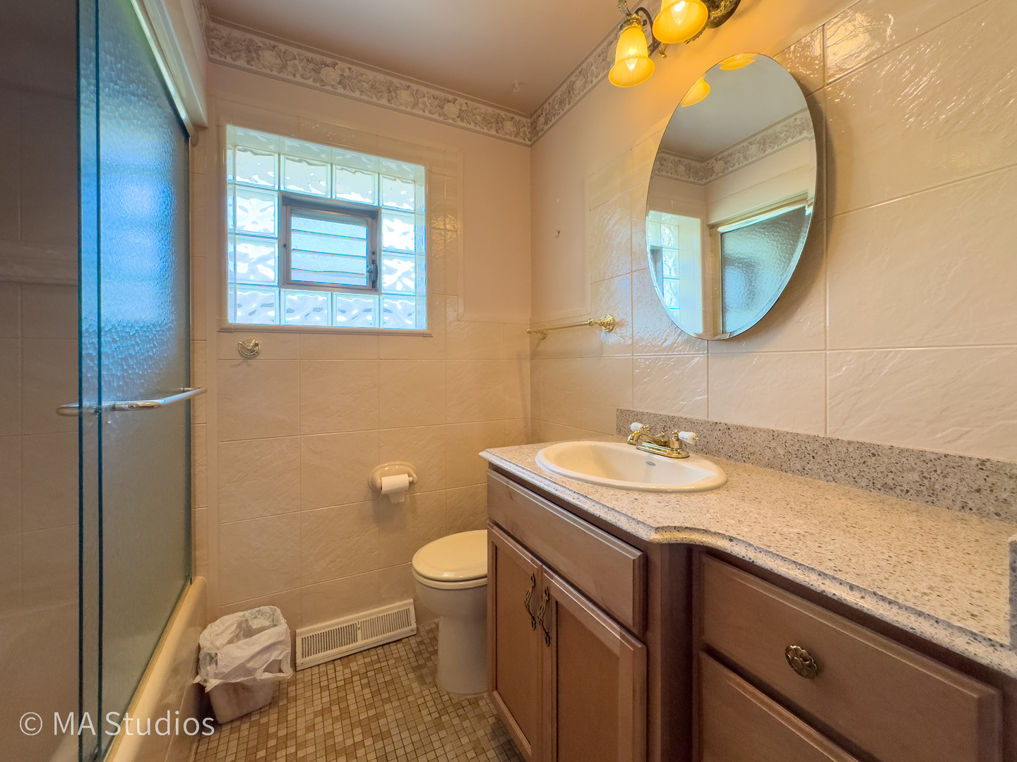 8636 40th Street Lyons, IL 60534 - Photo 24 of 50 a bathroom with a granite countertop toilet sink and mirror