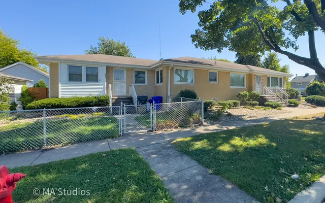 a front view of a house with a yard table and chairs