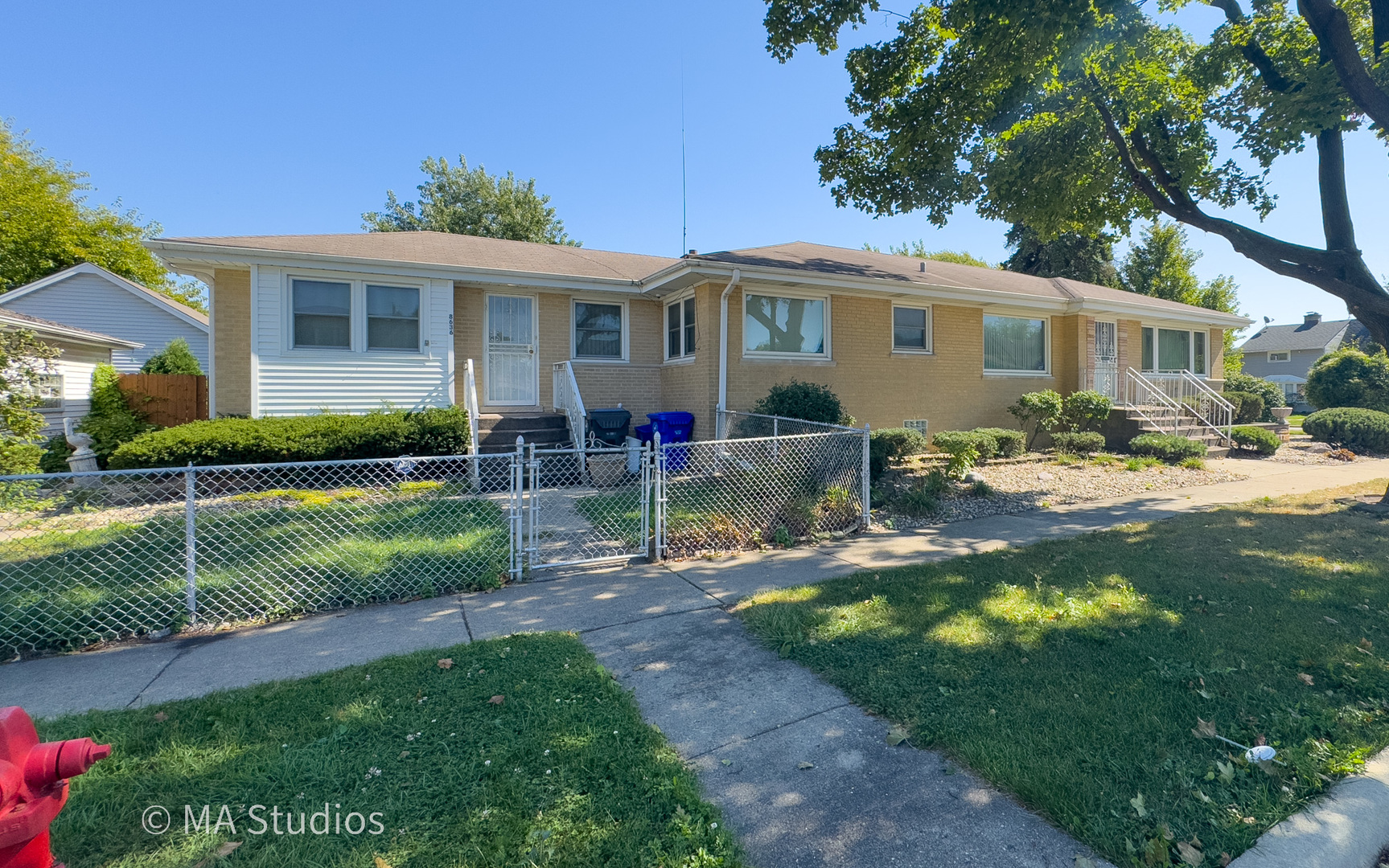 8636 40th Street Lyons, IL 60534 - Photo 3 of 50 a front view of a house with a yard table and chairs
