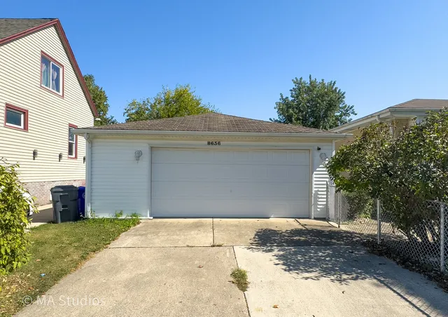 an aerial view of residential houses with outdoor space and trees