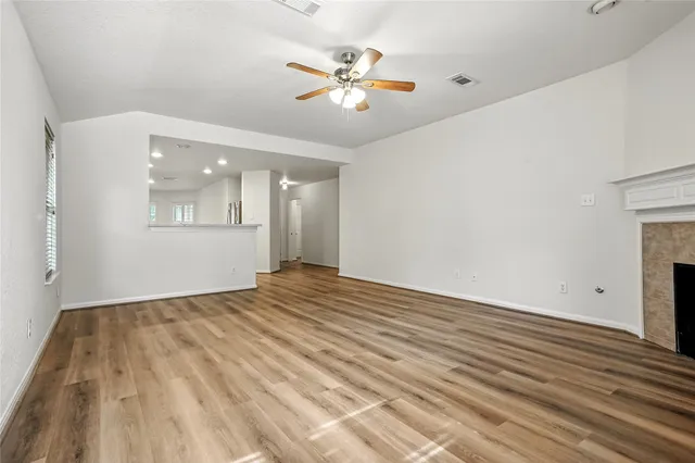 wooden floor in an empty room with a window