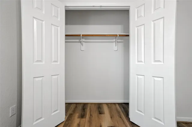 a view of closet with wooden floor