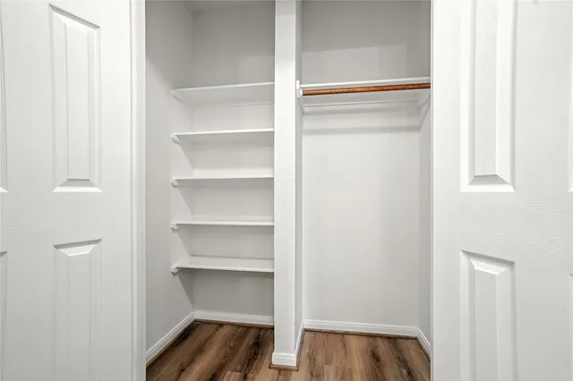 a view of walk in closet with empty racks