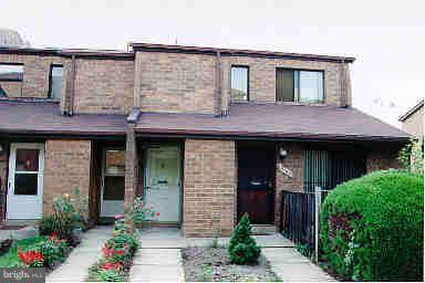 a front view of a house with plants