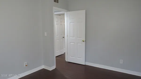 an empty room with wooden floor