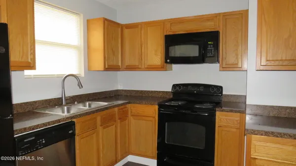 a kitchen with a sink stove and microwave