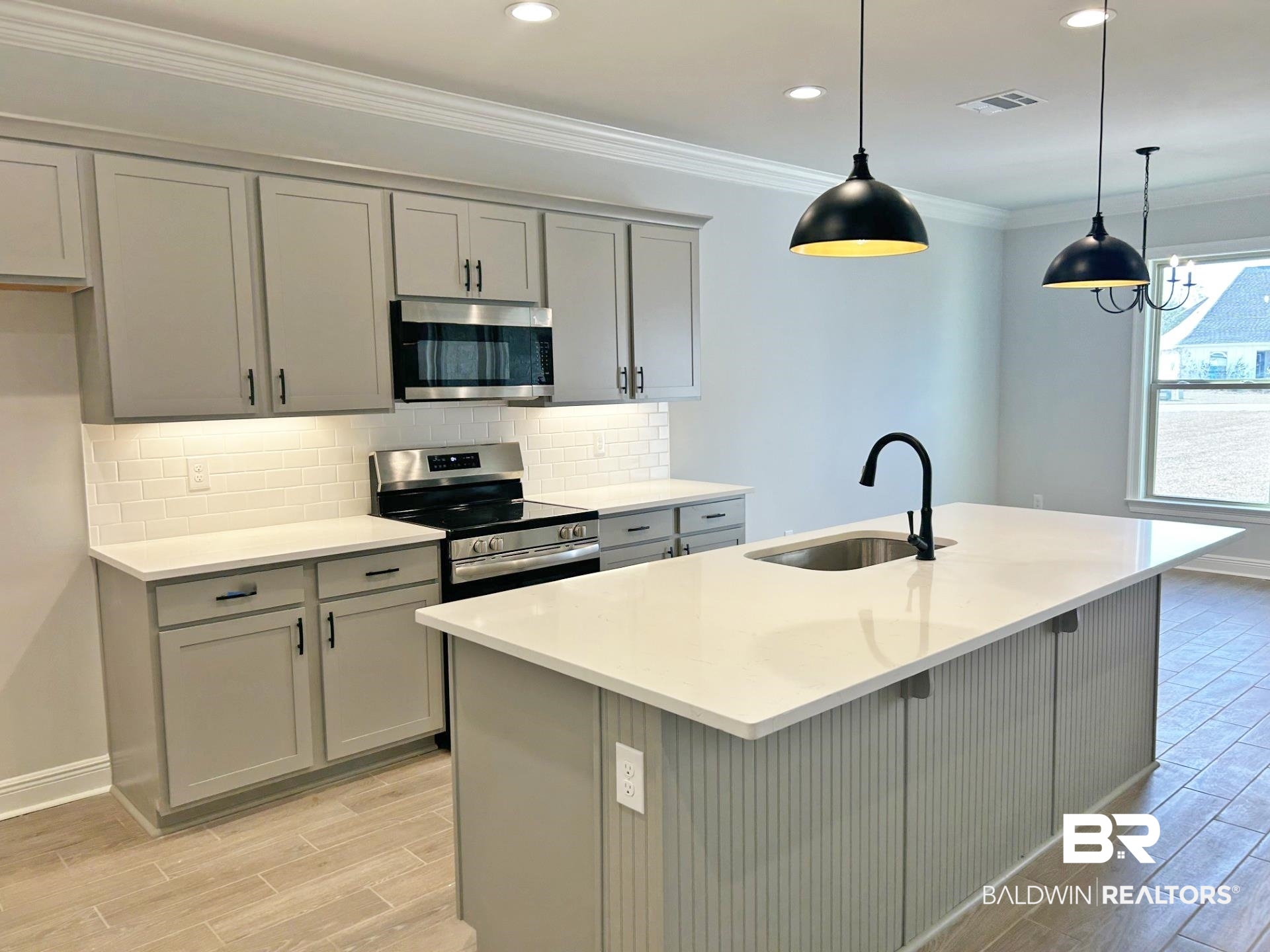 825 Sumter Loop Foley, AL 36535 - Photo 3 of 21 Kitchen featuring stainless steel appliances, gray cabinetry, decorative backsplash, pendant lighting, and wood tiled floors