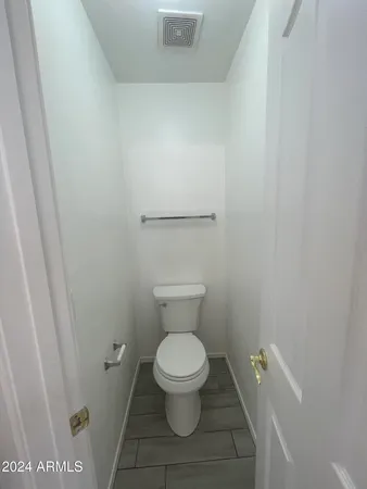 a white toilet sitting in a bathroom