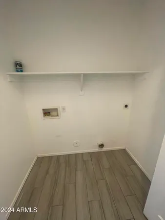 a view of a room with wooden floor and cabinets