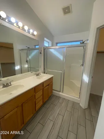 a bathroom with a double vanity sink a toilet and a mirror