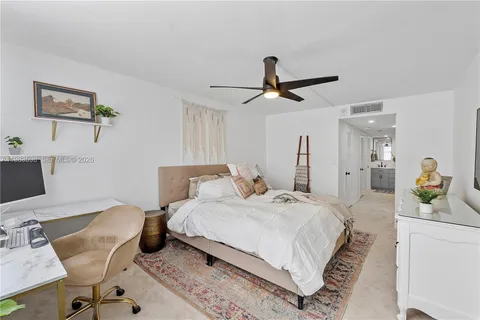 a bedroom with a bed a desk and chair