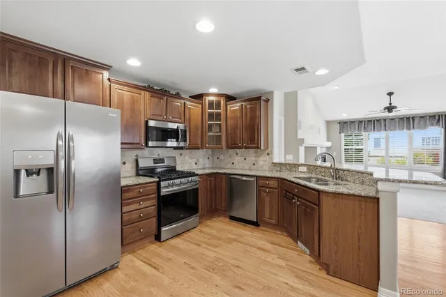 a kitchen with granite countertop a sink and cabinets